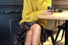 28 a mustard chunky sweater over a black floral dress and black cowboy boots for the fall
