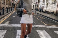 28 a simple everyday look with a grey long sleeve top, a white denim mini, black combat boots and a black crossbody bag