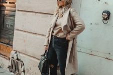 30 a casual chic fall look with a tan jumper, black ripped jeans, silver booties, a tan coat and a black bag