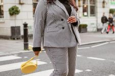 31 a black and white checked pantsuit, bold yellow trainers and a matching round bag and a black turtleneck