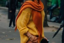 31 a bold fall outfit with rustc trousers, a yellow oversized sweater, an orange scarf and a brown bag with a ring handle