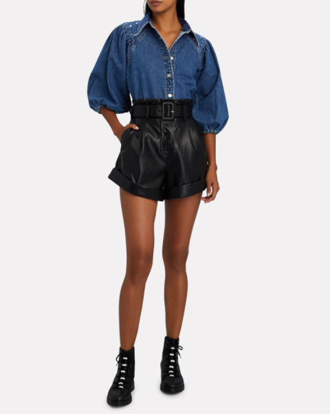 With black leather high-waisted shorts and black lace up ankle boots