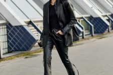 With black shirt, black leather blazer and black and silver boots