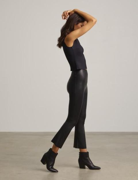 With black sleeveless top and black low heeled boots