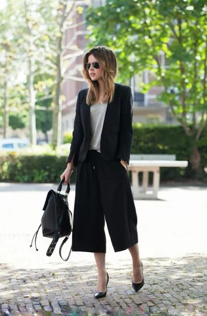 With gray loose shirt, black leather backpack and black pumps