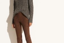 With gray loose sweater and black flat ankle boots