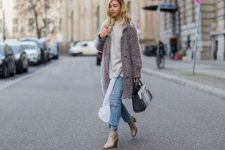 With gray loose sweatshirt, light gray leather boots, coat and three colored bag