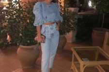 With high-waisted cropped jeans, embellished ankle strap sandals and printed clutch