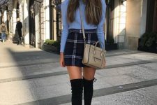 With high-waisted mini skirt, beige crossbody bag and black over the knee boots
