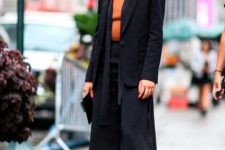 With orange shirt, black scarf, black clutch and printed leather mid calf boots