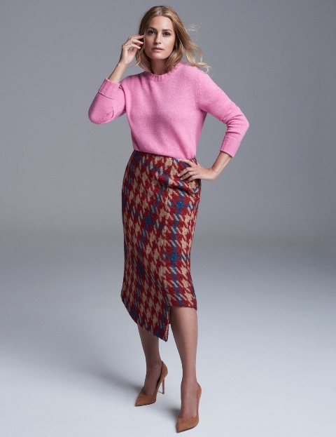 With pink sweater and brown suede pumps