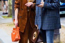 With plaid sweater, orange leather bag, rounded sunglasses and white boots