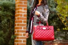 With printed t-shirt, jeans and red leather bag