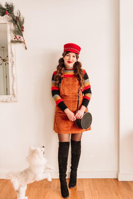 With red cap, striped sweater, over the knee boots and rounded bag