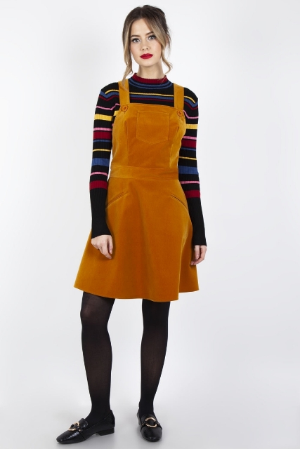 With striped long sleeve sweater, black tights and black flat shoes