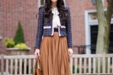 With white blouse, pleated knee-length skirt, brown bag and navy blue suede pumps