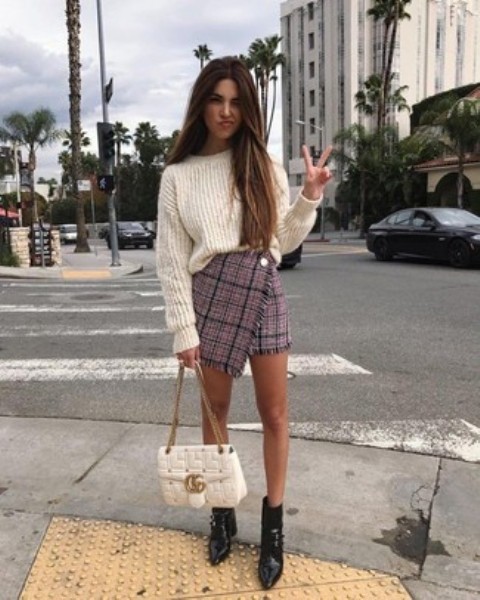 With white loose sweater, white chain strap bag and black leather boots
