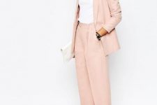 With white turtleneck, white leather clutch and beige pumps