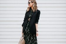 a black printed midi dress accented with a logo belt, a black oversized blazer, white booties, a tan tote for a chic work look