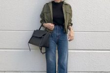 a black top, blue jeans, a green utility jacket, a black bag and snakeskin print shoes