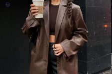 a brown crop top, a brown oversized leather blazer, black leather pants, statement jewelry for a bold look