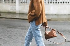 a brown oversized sweater, blue jeans, white booties and a brown bag compose a simple fall look