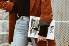 a chic fall outfit with a black turtleneck, bleached jeans, a rust-colored oversized corduroy pants, a black bag