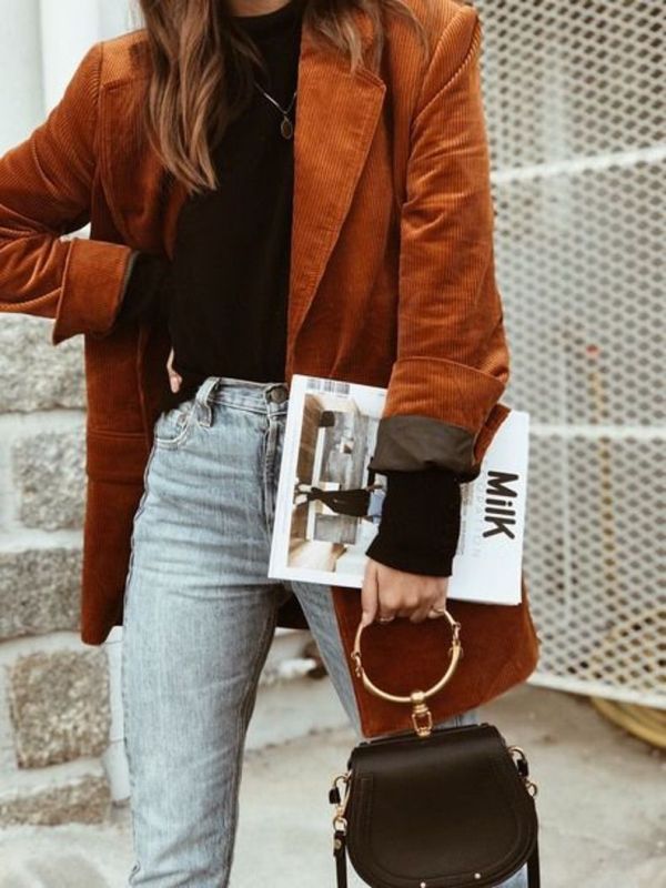 a chic fall outfit with a black turtleneck, bleached jeans, a rust colored oversized corduroy pants, a black bag