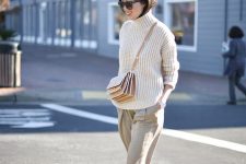 a chunky turtleneck sweater, neutral cropped culottes, neutral shoes and a pretty crossbody bag
