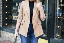 a classic look with a black turtleneck, blue skinnies, a tan corduroy blazer, tan booties and a black tote