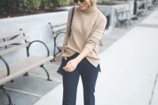 a classy outfit with a tan turtleneck sweater, navy pinstripe trousers, tan heels and a black bag for the fall