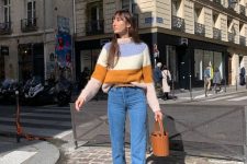 a color block sweater, blue cropped jeans, tan suede boots and a brown bucket bag for a French chic look