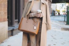 a comfotable outfit in tan, with a turtleneck, trousers, a coat, a brown bag and loafers for a chic fall work look