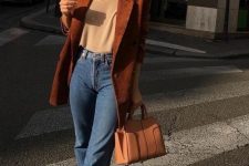 a comfy fall outfit with a neutral top, blue jeans, a tan bag, a rust-colored corduroy oversized blazer is amazing