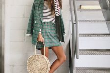 a grey and green plaid suit with a mini skirt, a striped long sleeve top, white sneakers and a woven bag for a summer to fall look