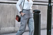 a lovely and stylish fall work outfit with a fuzzy jumper, grey high waisted cropped pants, spiked shoes and a bold bag