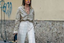 a lovely mix print look in neutrals, with a windowpane print shirt and windowpane wide leg trousers, black shoes and a black bag
