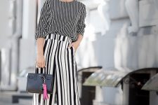 a minochromatic look with a vertical stripe long sleeve top, vertical stripe culottes, white shoes and a small bag