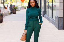a monochromatic fall look with an emerald turtleneck and pants, blush pumps and a tan bag is simple and cool