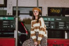 a mustard and white striped sweater, a leopard print midi skirt, white boots, an embellished bag and a mustard beret
