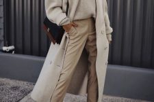 a neutral jumper, tan trousers, a creamy coat, white sneakers and a two tone bag for a bolder accent in the look
