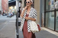 a pretty polka dot girlish look with an oversized blazer, a rust-colored midi dress, a clear bag and embellished shoes