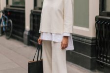 a pure minimalist fall work look with a white oversized shirt, a sweatshirt and trousers, white heels and a black tote