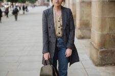 a refined fall look with a tan blouse, blue cropped jeans, a grey coat, black bootis and a black bag
