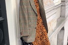 a rust-colored leopard print maxi dress, a grey plaid oversized blazer, black shoes and a clear bag for a trendy look