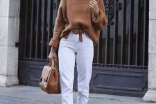 a rust-colored sweater, white slim leg jeans and sneakers, a tan belt and a tan bag for work