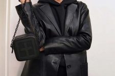 a total black look with a hoodie, jeans, a leather blazer and a small bag is a very comfy solution for the fall
