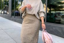 a very comfy and minimal flal work look with a grey turtleneck sweater, a tan midi skirt, white sneakers and a pink bag