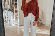 a very simple, cozy and stylish fall outfit with a rust-colored chunky sweater, white cropped jeans, rust-colored booties