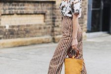 a white fauna print t-shirt, rust polka dot pants, mustard loafers and a matching bucket bag for a catchy look